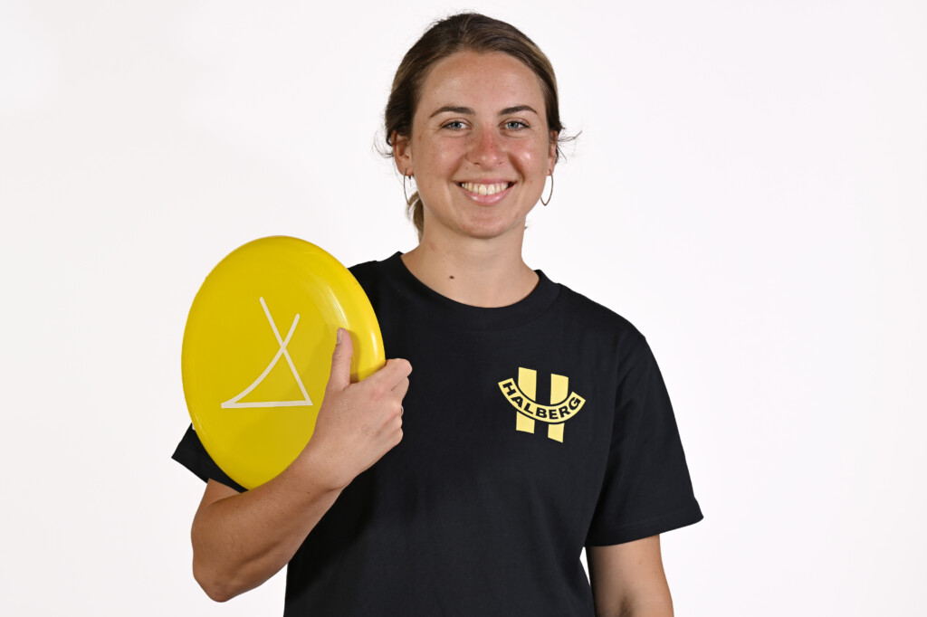 Women stands for photo with yellow frisbee